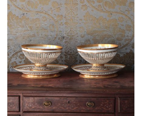 A PAIR OF DARTE FRÈRES PARIS PORCELAIN BASKETSmarked to the underside, the pierced oval bowls highlighted in gilt on conformi