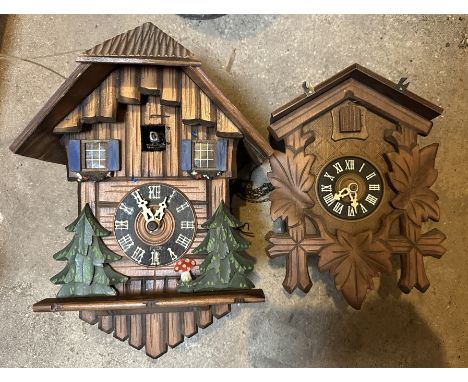 A POLYCHROME AND CARVED WOOD CUCKOO CLOCK&nbsp;20th century, 30cm tall x 22cm wide; together with a similar Black Forest styl