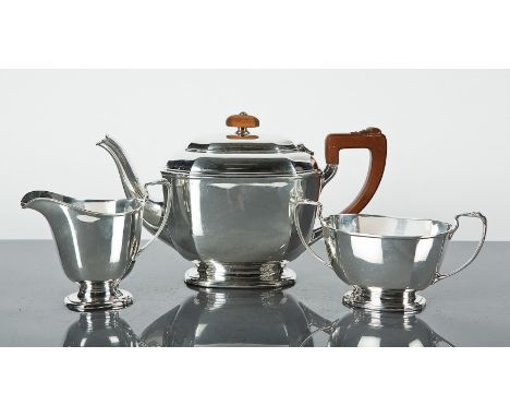 GEORGE V SILVER THREE PIECE TEA SERVICE
maker 'S Ltd',  Birmingham 1932, comprising a teapot, sugar and cream, of faceted for