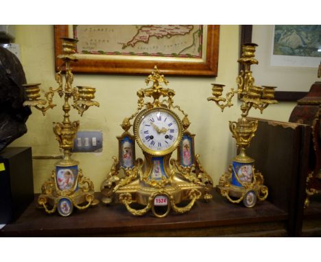 A Louis XVI style gilt brass and Sevres style clock garniture, the clock 37cm high. 