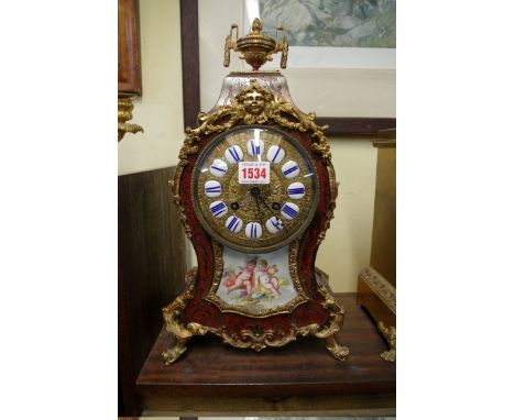 A Louis XVI style tortoiseshell boulle clock and porcelain mantel clock, 40cm high.