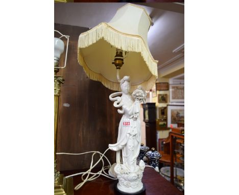 A Chinese blanc de chine figure of Guanyin, 37cm high, mounted on a lamp base.