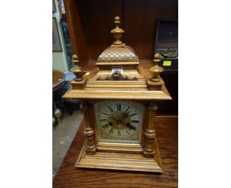 A Continental walnut mantel clock, 47cm high. 