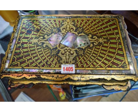 A Victorian papier-mache and mother of pearl games box, the hinged top enclosing five further boxes and covers, with playing 