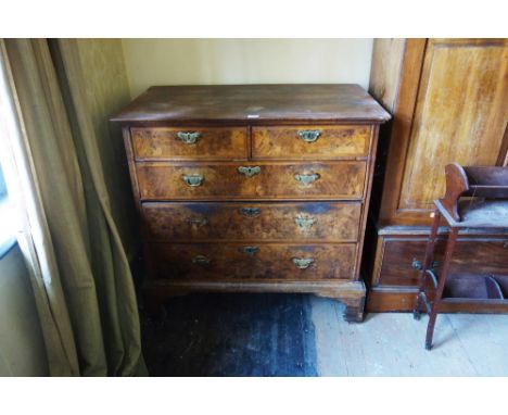 AN 18TH CENTURY WALNUT CHEST OF DRAWERS the quarter veneered and herringbone crossbanded top above an arrangement of two shor
