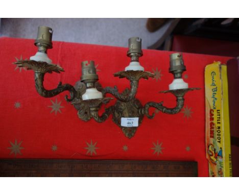 A PAIR OF GILT-METAL DECORATIVE WALL LIGHT FITTINGS with two candle arms 