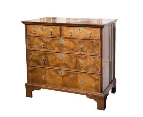 AN 18TH CENTURY WALNUT CHEST OF DRAWERS the quarter veneered and crossbanded top with herringbone inlay, above an arrangement