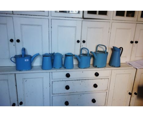 AN EDWARDIAN BLUE ENAMEL HOT WATER CAN two others; three lidded jugs and another jug (7) 