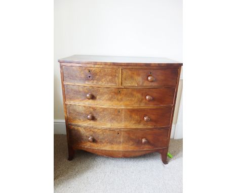 AN EARLY VICTORIAN MAHOGANY BOW FRONT CHEST OF DRAWERS with two drawers to the upper frieze and three long graduated drawers 