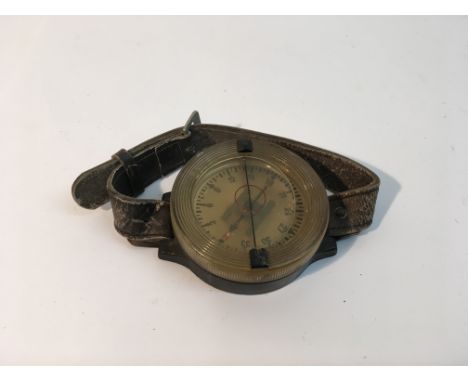 A WW2 German Luftwaffe wrist compass with leather strap markings to rear AK 39 FL 23235-1