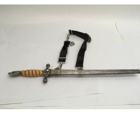 A German Kriegsmarine Administrative officers dagger with hanging straps attached to the scabbard, locking mechanism on the b