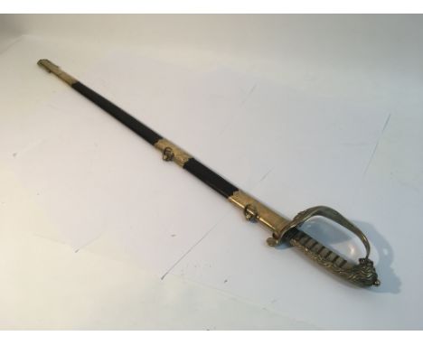 A Royal Navy Kings crown sword and scabbard with an etched blade, scabbard and folding guard