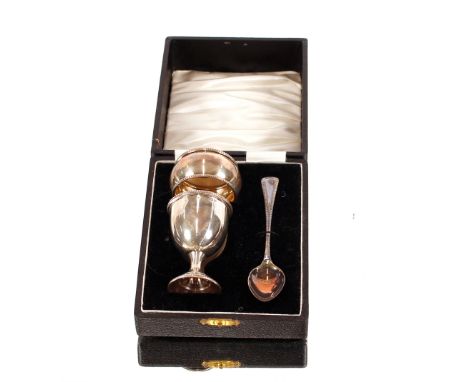 A cased silver egg cup, spoon, and napkin ring,&nbsp;