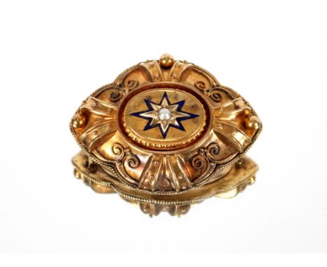 A Victorian yellow metal memorial brooch,&nbsp;decorated central seed pearl and enamel star with filigree work borders
