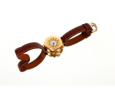 An 18ct gold half hunter wrist watch,&nbsp;having blue enamelled numerals, inner white enamel dial with second subsidiary, la