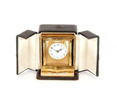 A brass carriage timepiece,&nbsp;of serpentine shape with circular white enamel dial contained in a leather covered travellin