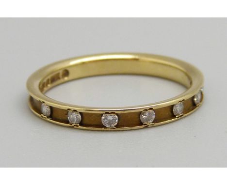 An 18ct gold seven stone diamond ring, 1.9g, M 