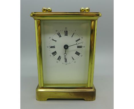 A brass and four glass sided carriage clock, with keys, (purchased from Pragnells of Stratford Upon Avon) 