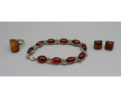 A silver and amber bracelet, ring and earrings 