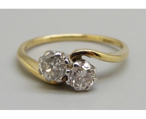 An 18ct gold two stone diamond crossover ring, K, 2.6g, total diamond weight approximately 0.6cts 