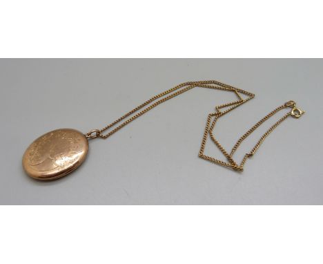 A vintage 9ct gold front and back locket on a 9ct gold chain, chain 3g 