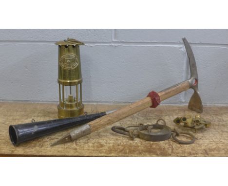 A miner's safety lamp with long service engraving, an ice pick, horn, scales and a brass instrument 