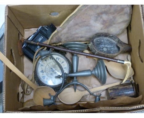 An antler handled riding crop with silver ferrule, a pair of pewter candlesticks, alarm clock, wooden beaker, folding camera,