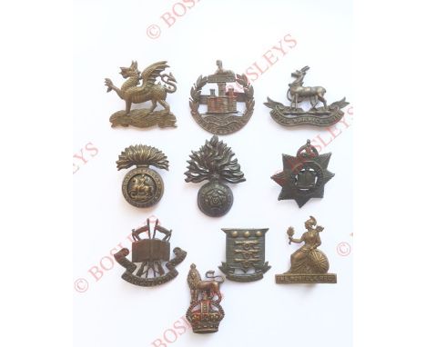 10 various OSD bronze cap badges Buffs ... Dorsetshire ... R. Warwickshire (Firmin tablet) ... Northumberland Fusiliers (Gaun
