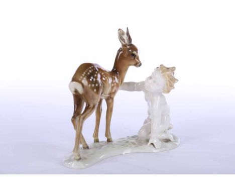 HUTSCHENREUTHER FIGURE GROUP BY K. TUTTER
modelled as a fawn and a putti, over a shaped naturalistic base, green factory mark