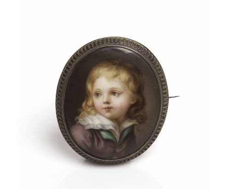 HAND-PAINTED PORTRAIT MINIATURE 
depicting a young boy, painted on ceramic and mounted in a brooch, 7cm high 