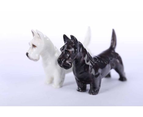 TWO ROYAL DOULTON FIGURES OF TERRIERS
one in black and the other in white, gold printed mark to underside, numbered 2945 and 