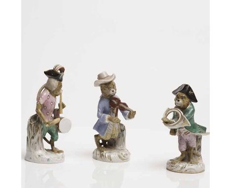 GROUP OF THREE CONTINENTAL PORCELAIN FIGURES
each in the form of a monkey band player, 14cm-12.5cm high 