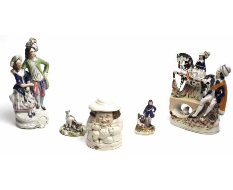GROUP OF STAFFORDSHIRE FIGURES
including a flatback of a woman on horseback on a bridge, also a toby figure lidded jar 