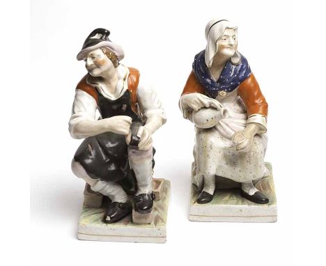 PAIR OF STAFFORDSHIRE FIGURES
of a male and female, both seated, 32cm high 