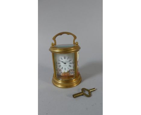 An Elliot and Son Circular Brass Cased Carriage Clock with 19th Century Style Porcelain Panels Depicting Cherub Catching Butt