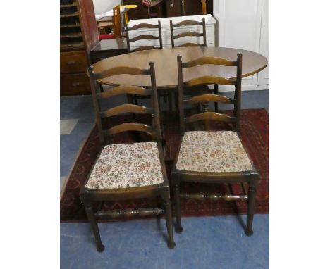 An Oak Drop Leaf Table and Four Ladder Back Dining Chairs