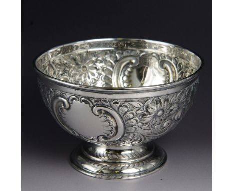 Edwardian silver rose bowl, of circular form, embossed with floral and C scroll decoration, upon a circular stepped foot, hal