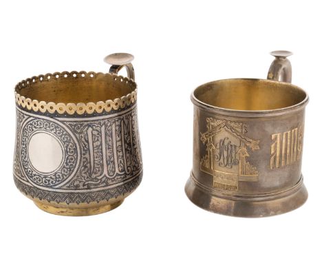 A PAIR OF RUSSIAN SILVER GILT AND NIELLO CUP HOLDERScomprising: a) silver gilt cup holder, niello old russian ornament with o