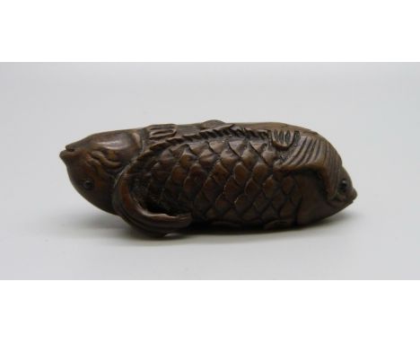 An ironwood netsuke of two fish 