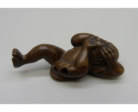 An ironwood netsuke of a 'No Evil Monkey' 