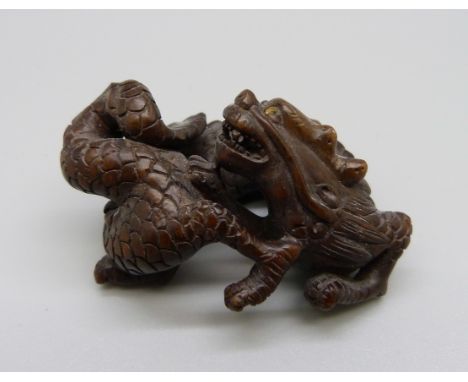 An ironwood netsuke of a dragon 