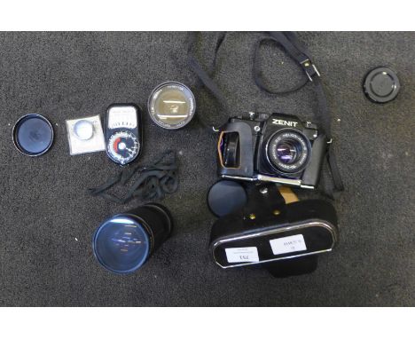 A Zenit camera, two lenses and a light meter 