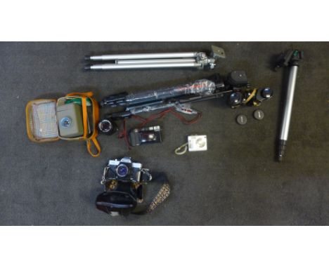 A collection of cameras and equipment, slide projector, binoculars and tripods 