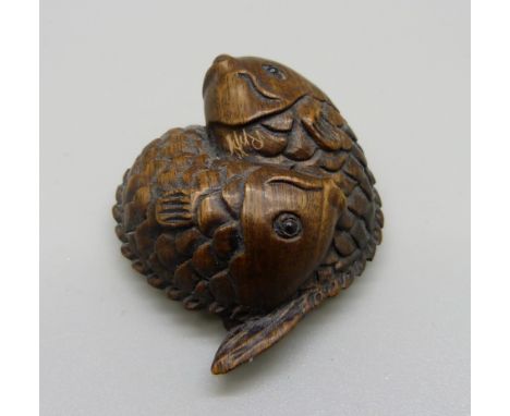 An ironwood netsuke of two fish 