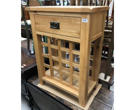 A modern light oak side table, the plank top over a single drawer and sixteen section wine rack on square legs 61 cm wide x 3