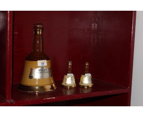 An old Wade pottery 26 2/3 fluid ounce decanter of Bell's Old Scotch Whisky, 24 cm high with contents and two similar ditto (