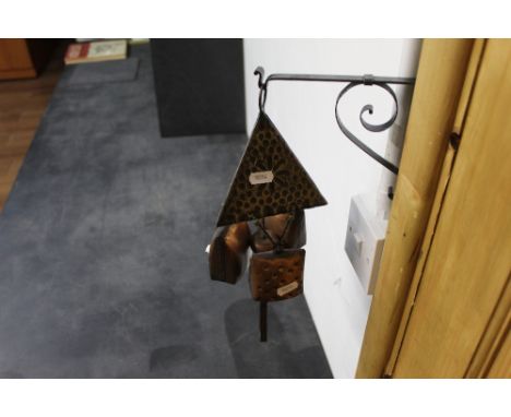 A copper and steel three division wind chime with bracket 