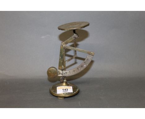 A set of late Victorian brass postal scales,16 cm high (slight denting and wear).