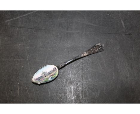 An early 20th century continental 800 standard white metal souvenir teaspoon, the bowl enamelled with Glasgow exhibition 1901