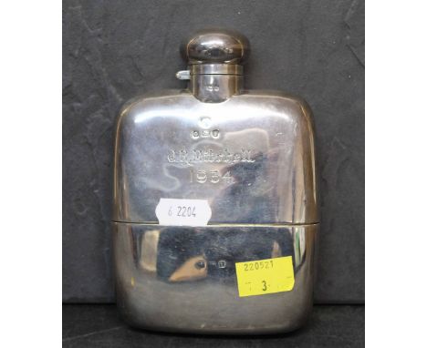 An Edward VII silver hip flask with slightly curved body and integrated cup, 14.5 cm x 10 cm, hallmarked for Birmingham 1908,